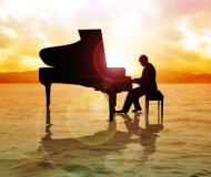 Stock image of a man silhouette playing piano on water